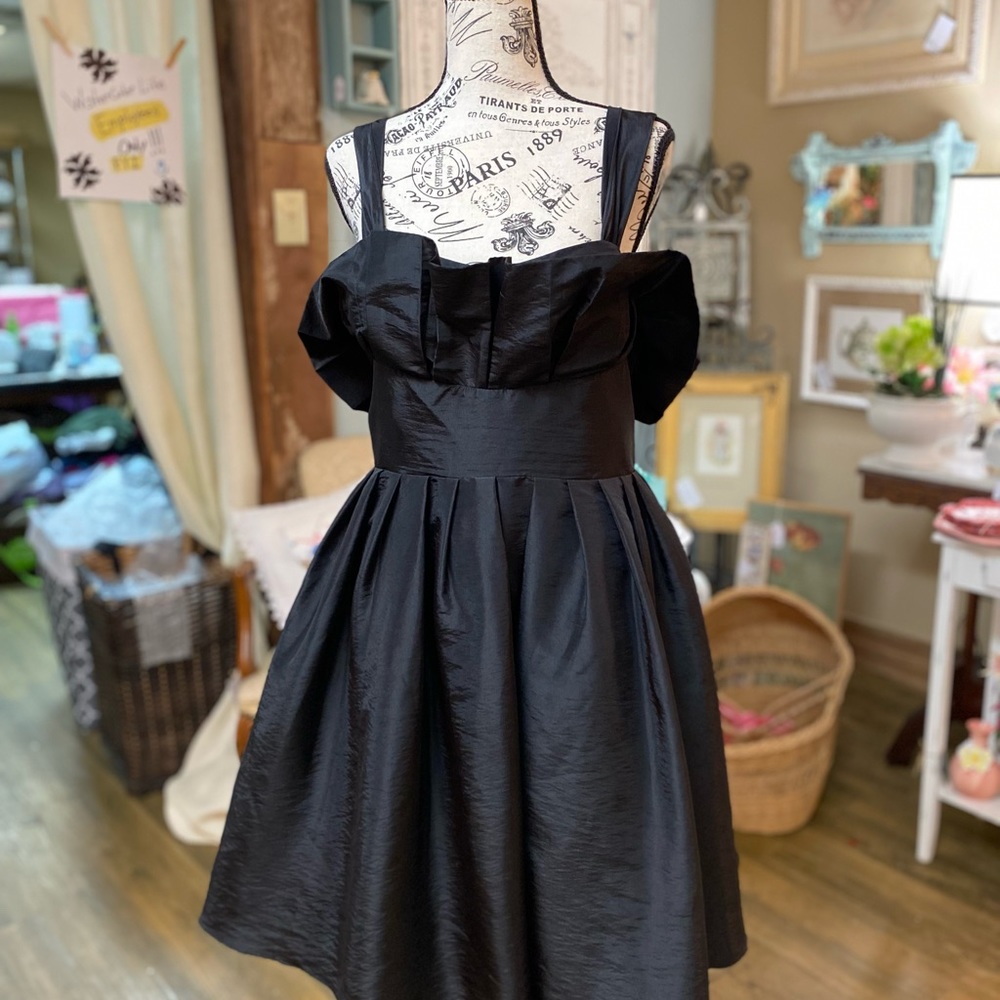 Black cocktail dress with pockets.